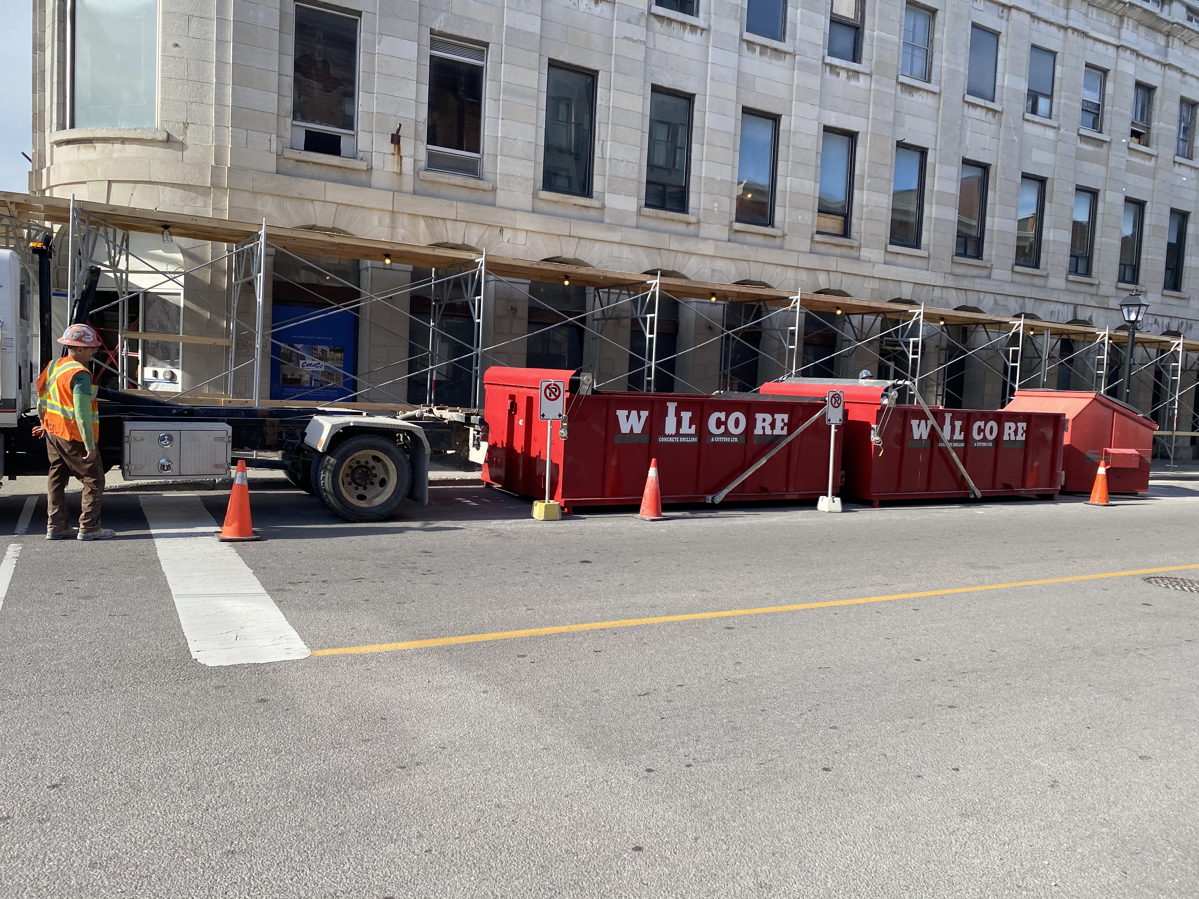 Photo of a Wilcore truck and Wilcore dumpsters in a downtown setting